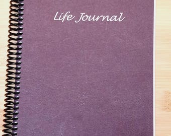May include: A purple spiral bound journal with the words "Life Journal" printed in white on the front cover.