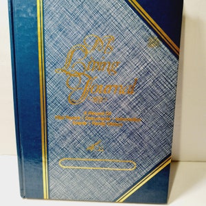 May include: A blue hardcover journal with gold accents and the title "My Living Journal" in gold lettering. The journal is a record of life events, documents, reflections, awards, and family history.