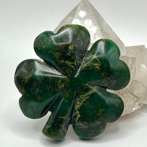 May include: A green four-leaf clover carved from stone. The clover is a symbol of good luck and fortune.
