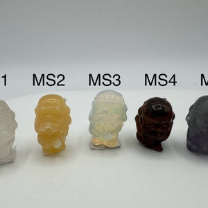 May include: Five small, hand-painted figurines of a character from the Star Wars franchise. The figurines are made of different materials, including clear, yellow, white, brown, and purple.