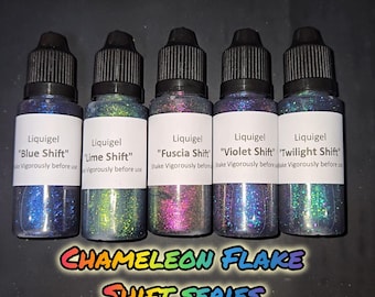 May include: Five bottles of Liquigel in the "Chameleon Flake Shift Series" with various color shifts. The bottles are labeled "Blue Shift", "Lime Shift", "Fuscia Shift", "Violet Shift", and "Twilight Shift". Each bottle has a black cap and a white label.