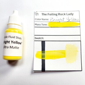 May include: A small bottle of bright yellow acrylic paint labeled "Bright Yellow" Ultra Matte. The paint is from The Foiling Rock Lady and is shown next to a swatch of the color on a white card.