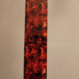 May include: A vertical image of a fiery orange and red flame pattern. The flames are abstract and appear to be moving upwards.