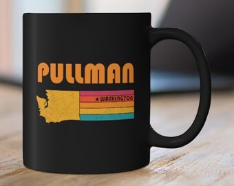 May include: Black ceramic coffee mug with a white outline of the state of Washington and the text "PULLMAN WASHINGTON" in orange letters.
