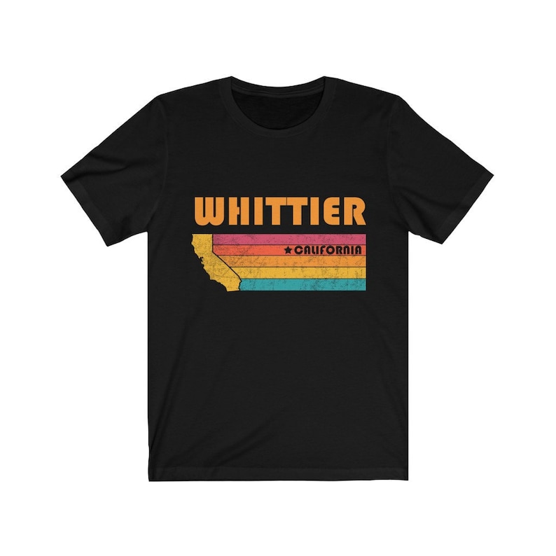 May include: Black t-shirt with a vintage-style graphic of the state of California with the text "WHITTIER" and "CALIFORNIA" in orange.