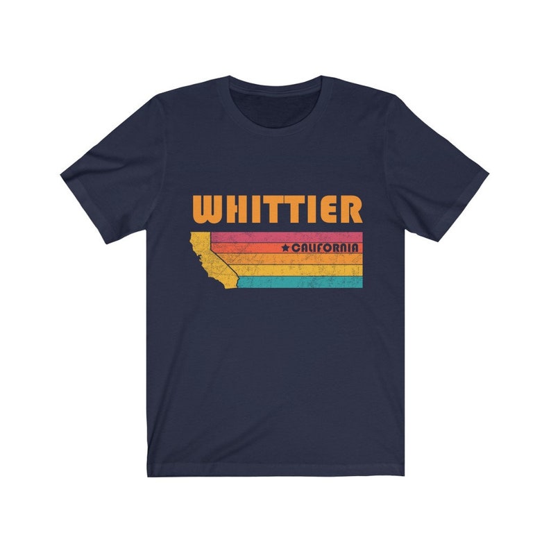 May include: Navy blue t-shirt with a vintage-style graphic of the state of California with the text "WHITTIER" and "*CALIFORNIA" in orange.