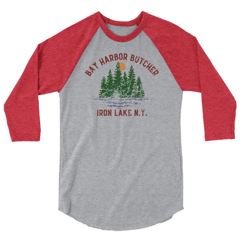 May include: A grey and red baseball tee shirt with the text "Bay Harbor Butcher Iron Lake N.Y." and a graphic of a forest with a sun.