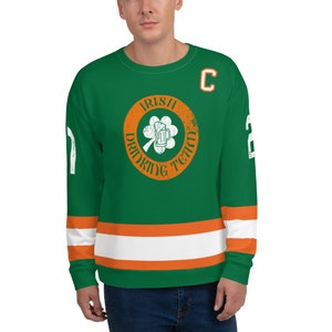 May include: Green and orange hockey jersey with the text "Irish Drinking Team" in a circle with a shamrock and a beer mug. The jersey has a white "C" on the chest and a white number "2" on the right sleeve.