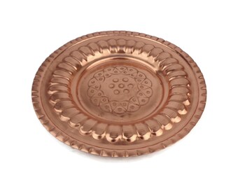 May include: A round copper plate with a decorative design in the center. The plate has a raised rim and a smooth, polished surface.
