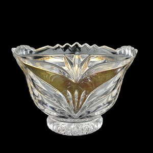 May include: A clear glass bowl with a scalloped rim and a cut glass design. The bowl has a gold iridescent finish and sits on a pedestal base.