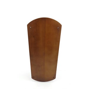 May include: A brown wooden ceiling fan blade with a curved shape.