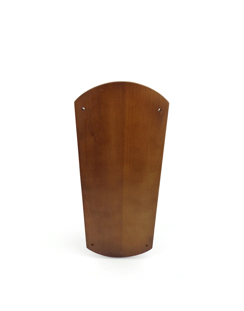 May include: A brown wooden ceiling fan blade with a curved shape.