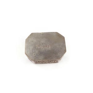 May include: Octagonal silver box with intricate engraved details on the sides and a stamped inscription on the bottom.