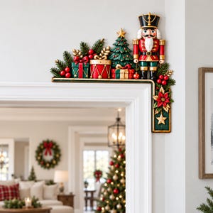 May include: A decorative Christmas door corner sign featuring a nutcracker, a decorated pine tree, and wrapped gift boxes. The design includes red berries, green pine needles, a gold star, and a poinsettia flower with a hanging star ornament.