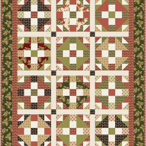 May include: A patchwork quilt with a Christmas theme. The quilt features a repeating pattern of squares and triangles in red, green, cream, and black fabrics. The border is a dark green with a holly leaf design.