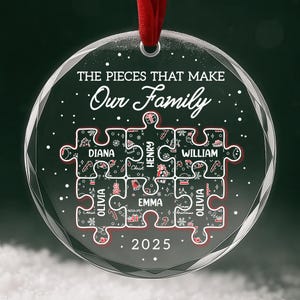 May include: A clear, round Christmas ornament with a red ribbon. The ornament features a puzzle design with family names and the text "THE PIECES THAT MAKE Our Family" and the year 2025. The puzzle pieces are decorated with festive holiday elements.