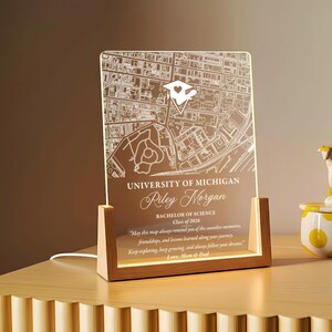 May include: A lighted acrylic map of the University of Michigan, personalized with a name, degree, and class year. The map is set in a wooden frame and includes a heartfelt message. A unique graduation gift.