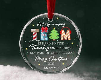 May include: A round clear acrylic Christmas ornament hanging from a red ribbon. The text reads A truly amazing TEAM IS HARD TO FIND Thank you for being a KEY PART OF OUR SUCCESS Merry Christmas 2025 CG GROUP with holiday graphics.
