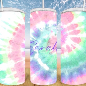 May include: Three stainless steel tumblers with a tie-dye pattern in shades of pink, green, and blue. The middle tumbler has the name "Sarah" written in purple on the front.