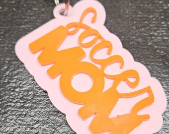 May include: Orange "Sassy Mom" keychain with a pink background and a silver key ring.