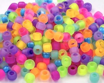 May include: A large assortment of colourful, translucent plastic beads. The beads are round and have a frosted finish. They are perfect for making jewellery, crafts, and other projects.
