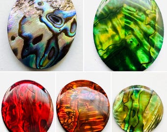 May include: Five oval-shaped abalone shell cabochons in various colors. The shells display iridescent patterns of blue, green, red, and gold. The cabochons are smooth and polished, showcasing the natural beauty of the abalone shell.