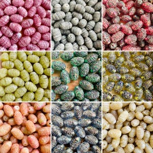 May include: A collage of nine close-up images showcasing various handmade beads. The beads are oval-shaped and come in a variety of colors, including pink, gray, red, green, yellow, and beige. The beads have a textured surface.