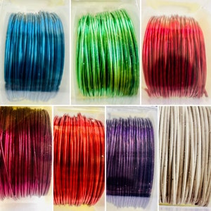May include: Assortment of colorful metallic wire spools in blue, green, red, burgundy, orange, purple, and beige.
