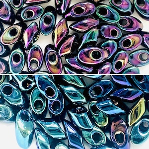 May include: An assortment of iridescent oval and diamond-shaped beads. The beads have a dark base color with a shimmering, multi-colored finish, reflecting hues of purple, green, and gold. Each bead has a central hole for stringing, ideal for jewelry making.