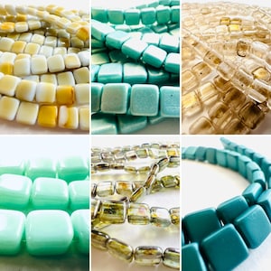 May include: A collage of square glass beads in various colors. The beads are in shades of yellow, light blue, clear, and green. The beads are strung together, and the image is a close-up of the beads.