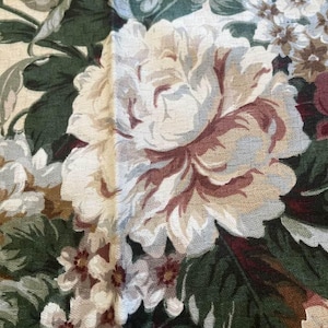 Burgundy flowers set against a white background  by Wellington Sears