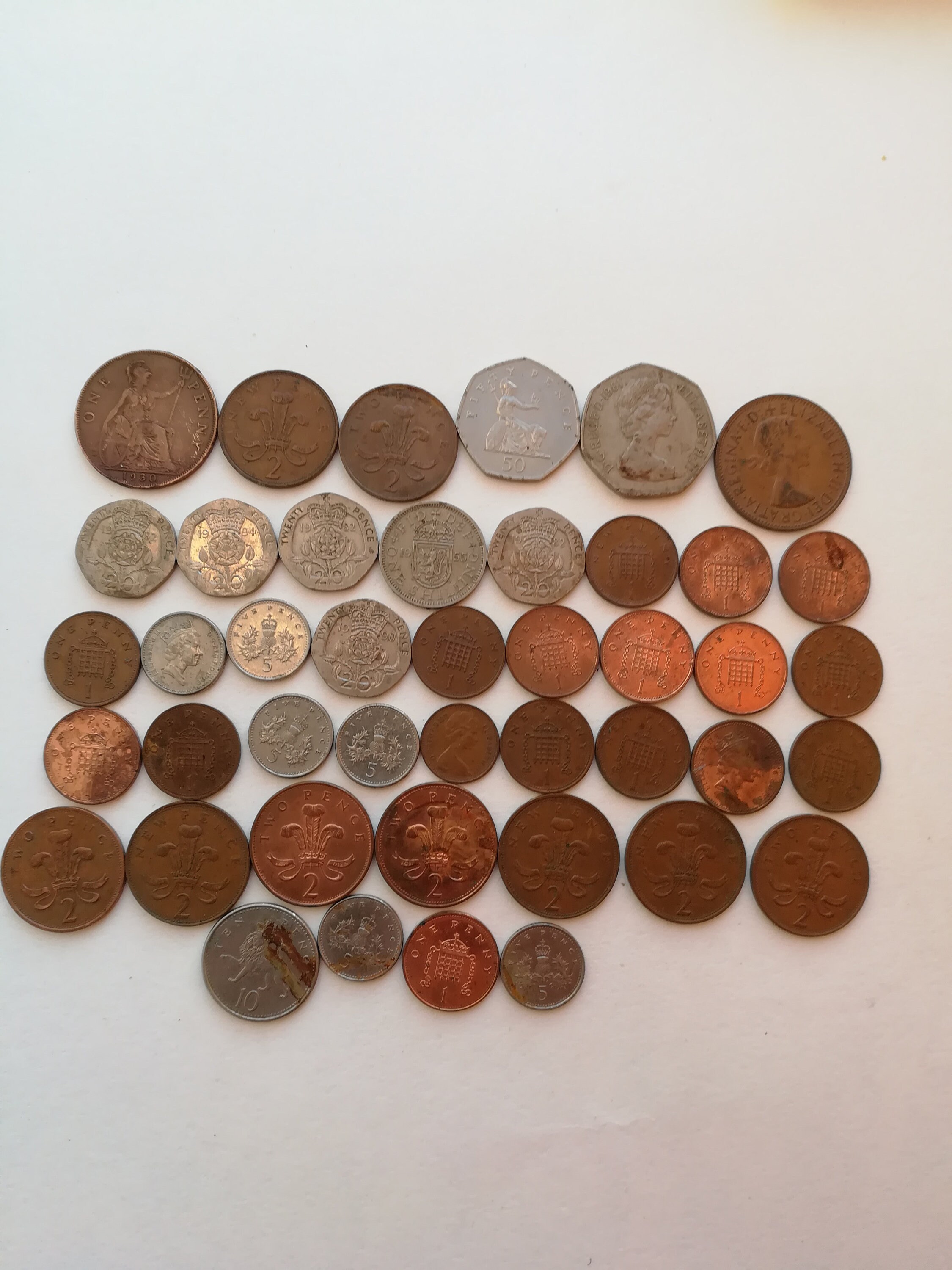 British coins, UK pennies and shillings, on a collectible plate