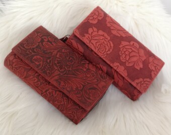 Women's wallet or purse made of genuine buffalo leather Compact with many credit card slots in terracotta and red color.