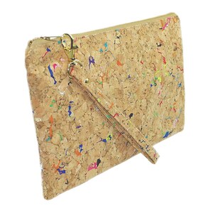 May include: A cork clutch bag with a colorful splatter paint design and a gold zipper. The bag has a detachable strap.