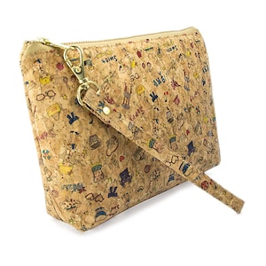 May include: A cork clutch bag with a zipper closure and a detachable strap. The bag is covered in a colorful pattern of doodles and illustrations.
