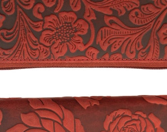 Women's wallet or purse made of genuine buffalo leather Compact with many credit card slots in terracotta and red color.