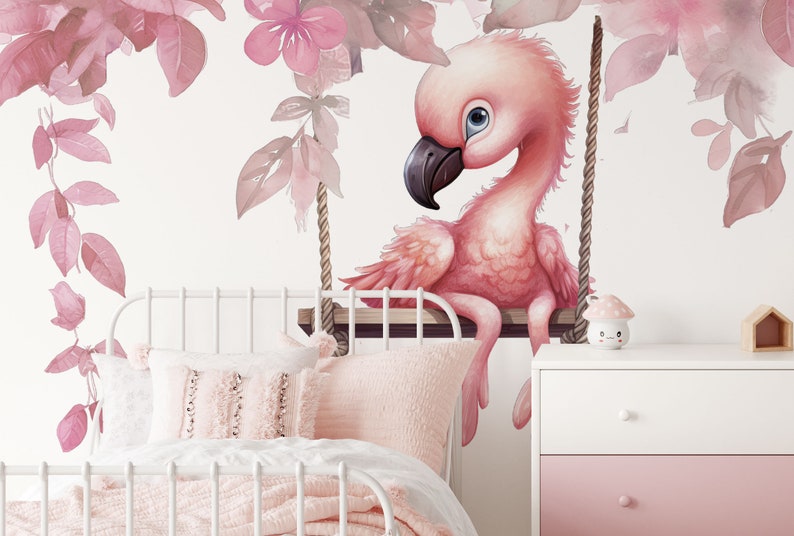 May include: A pink flamingo with blue eyes sits on a swing made of rope and wood. The flamingo is surrounded by pink watercolor leaves and flowers.