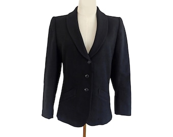 May include: A black blazer with a notched lapel, three-button closure, and two front pockets. The blazer is displayed on a mannequin and has a classic, tailored design. The fabric appears to be a solid, dark color.