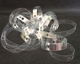 May include: Clear plastic balloon ribbon with evenly spaced holes for tying balloons. The ribbon is designed to create a balloon arch or garland.