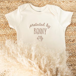 Embroidered Protected By Dog Baby Onesie®: Personalized Newborn Gift for Pregnancy Announcement