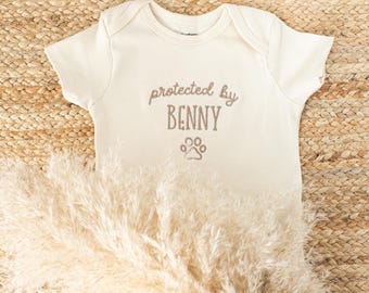 Embroidered Protected By Dog Baby Onesie®: Personalized Newborn Gift for Pregnancy Announcement
