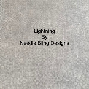 May include: A close-up of a light gray fabric with the text "Lightning By Needle Bling Designs" printed in black.