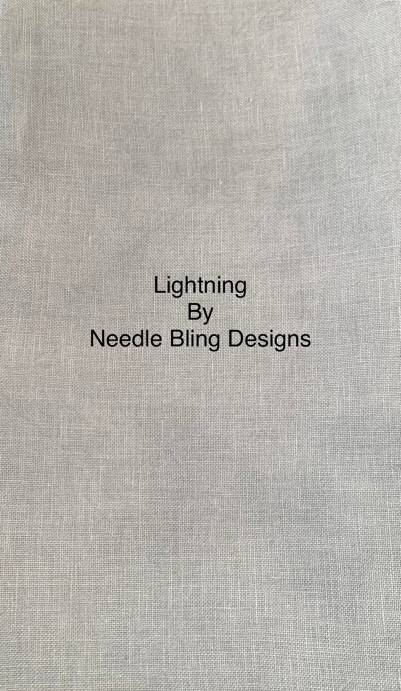 May include: A close-up of a light grey fabric with the text "Lightning By Needle Bling Designs" printed in black.