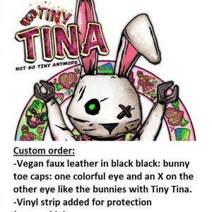 May include: Illustration of a white bunny with pink-lined ears, a green eye, and an X on the other eye. The bunny has black hands and is surrounded by a pink arch with tattoos. The text "TINY TINA" is above the bunny.