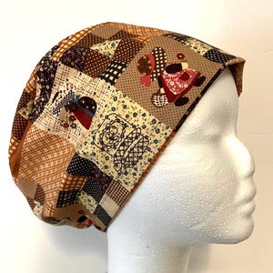 May include: A patchwork fabric cap in shades of brown, beige, and cream. The cap features a variety of patterns, including floral prints, polka dots, and geometric shapes. One section of the cap has an image of a woman carrying a basket.