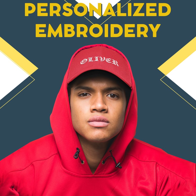 May include: A person wearing a red hooded sweatshirt and a red baseball cap with the word "OLIVER" embroidered in white on the front.