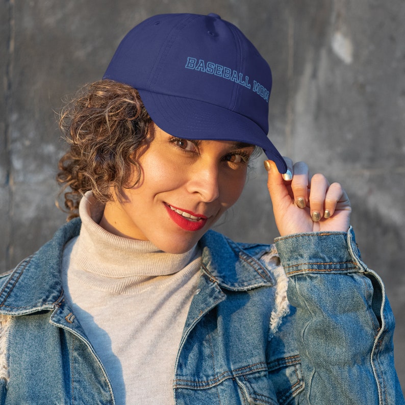 May include: A navy blue baseball cap with the text "BASEBALL MOM" embroidered in white.