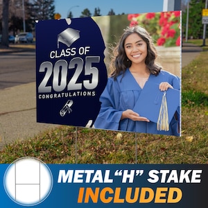 May include: A graduation yard sign with a navy blue background and silver text that reads "Class of 2025 Congratulations." The sign features a photo of a smiling graduate in a blue gown and cap. A metal stake is included.