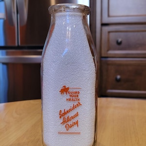 May include: A rustic wooden sign with the text "Welcome to our home" in white lettering. The sign features a distressed finish and a simple, inviting design, perfect for front door decor.