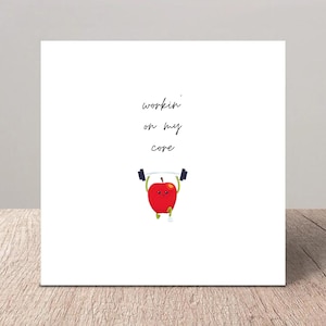 May include: A red apple with a smiling face is lifting a barbell with the text "workin' on my core" above it.